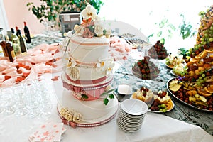 Restauant table with wedding cake and fruits