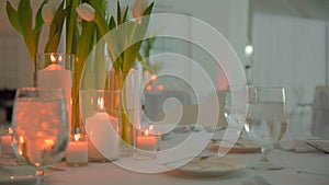 Restaurant banquet table set up served dinner tableware and silverware on event.