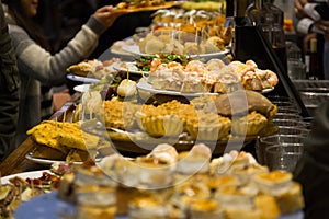 Restaurant bar full of plates with variety of pintxos