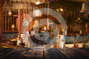 Restaurant bar table background. Blurred interior cafe restaurant with wooden desk for product. Selected focus