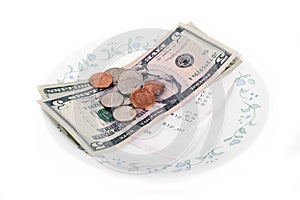 Restaurant bill with dollar bills (tips) on a plate