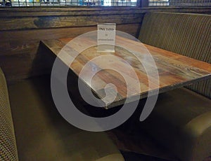 Restaurant booth closed to customers to comply with social distancing photo