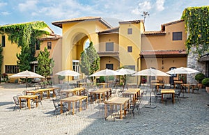 Restaurant cafe table with chair and umbrella in large building