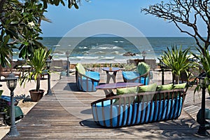 Restaurant chairs and cushions against the sea