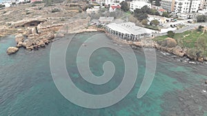 A restaurant at coastline of Kyrenia, Cyprus - Aerial Drone View 4K
