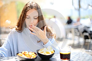Restaurant customer eating and licking finger