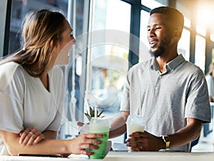 Restaurant, date and couple drinking milkshake while talking, bonding and laughing together. Happy, love and interracial