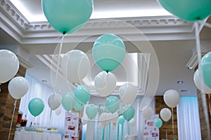 Restaurant decorated with white and turquoise balloons