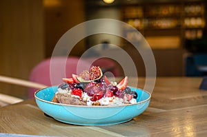 Restaurant dessert.  Sweet breakfast.Egg toast with fruits on top. Figs, raspberries, strawberries, mint,  blueberry fruits