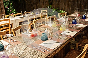Restaurant dinner table set for in the restaurant garden, outdoor. Banquet rustic