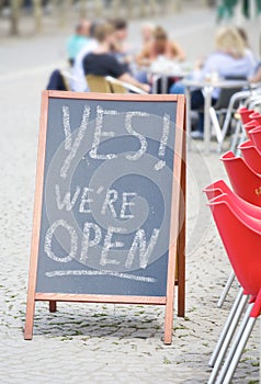 Restaurant display announcing reopening after the corona lockdown, gastronomy business open sign outdoors