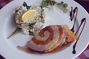 Restaurant feed. Salmon with risotto. Fish and rice Fish with lemon. Dish in the restaurant. National