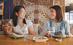 Restaurant, girl friends and laughing with food, noodles and cafe happy from bonding. Asian women, eating and plate