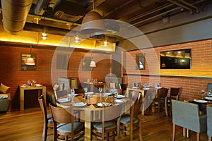 Restaurant hall with wooden round table in the