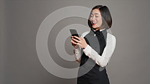Restaurant hostess texting messages to confirm reservations on phone app photo