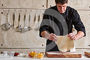 Restaurant hotel private chef preparing pizza rolling flattening