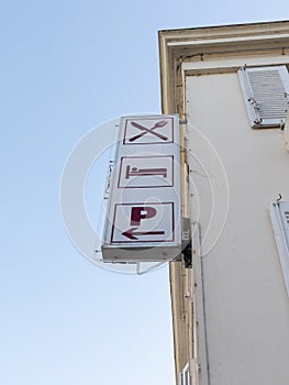Restaurant hotel signboard icon logo sign on wall facade entrance in city street