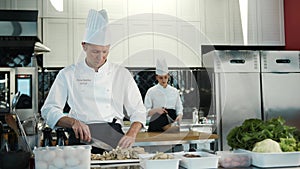 Restaurant Kitchen: Portrait of Male and Female Chefs Preparing Dish. Two Professionals Cooking Delicious, Authentic Food, Healthy