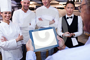 Restaurant manager briefing to his kitchen staff