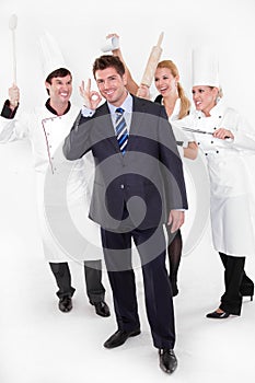 Restaurant manager with crazy staff behind