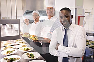 Restaurant manager with his kitchen staff photo