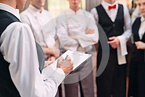 Restaurant manager and his staff in kitchen. interacting to head chef in commercial kitchen.