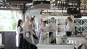 Restaurant manager and his staff in terrace. Interacting to head chef in restaurant