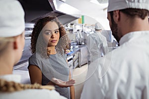 Restaurant manager interacting with his kitchen staff