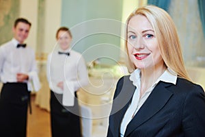 Restaurant manager with waitress and waiter photo