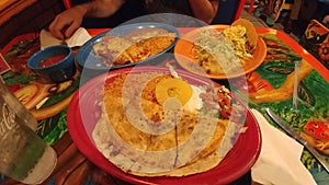 Mexican feast food on colorful table plates pina