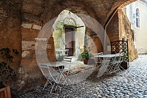 Restaurant in a narrow street of the village Saint Montan in the photo