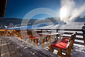 Restaurant with open terrace on ski resort at sunny day