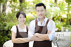 Restaurant owner standing with partner