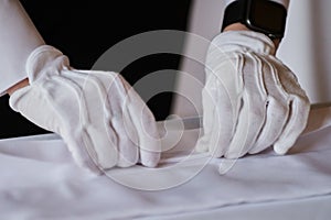 Restaurant personnel preparing the fine dining table.