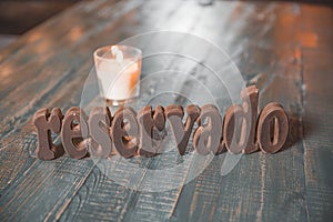 Restaurant reserved table sign with places setting and candle