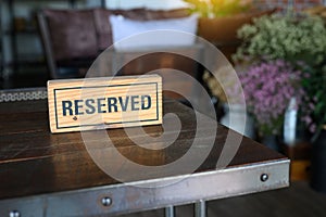 Restaurant reserved table sign Reserved Table. A tag of reservation placed on the wood table