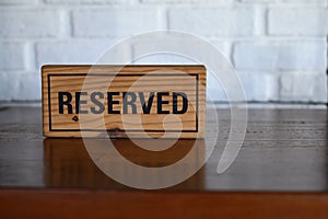Restaurant reserved table sign Reserved Table. A tag of reservation placed on the wood table