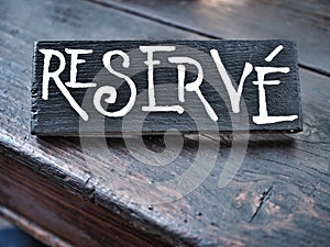 Restaurant reserved table sign on wooden table