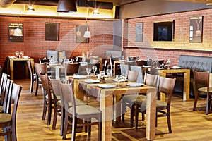 Restaurant room with wooden furniture and walls of