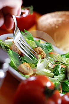 Restaurant salad on wooden table.