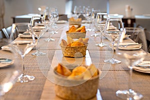Restaurant table for multiple diners with bread baskets photo