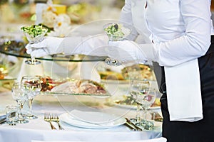 Restaurant services. Female waitress serving table