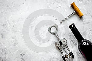 Restaurant set with wine bottle and corkscrew on stone top view