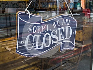 A restaurant `Sorry, we`re closed` glass door sign.