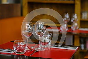 Restaurant table with cutlery and glassware.