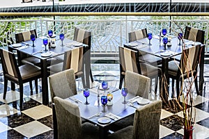 Restaurant table seatings with beautiful table settings with glassware, cutlery and napkins