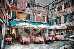 Restaurant tables and chiairs in a small square