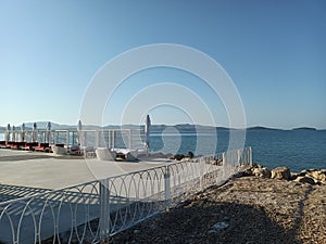 A restaurant terrace, where every table is graced with a view of the sea and distant islands photo