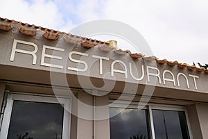 A restaurant text sign on facade building city street storefront