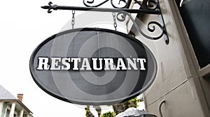 Restaurant text sign on panel board facade building city street storefront